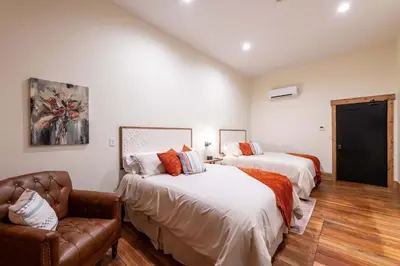 a bedroom with two beds and a couch in it at Cozy Corner - Room 5 in Versailles
