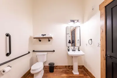 a bathroom with a toilet and a sink at ADA Suite - Room 6 in Versailles