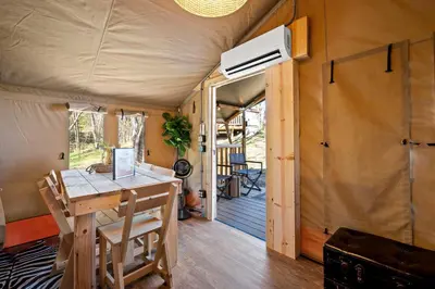 a tiny house with a desk and a ceiling fan at Eden Reserve Glamping Tents - All 8 Tents in Williamstown