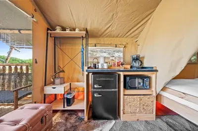 a small kitchen in a tent with a stove at Eden Reserve Glamping Tents - All 8 Tents in Williamstown