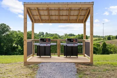 a gazebo with two burners in a field at Eden Reserve Glamping Tents - All 8 Tents in Williamstown