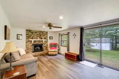 a living room with a couch and a fireplace at 1 Mi to Freer Field Ashland Home with Yard! in Ashland