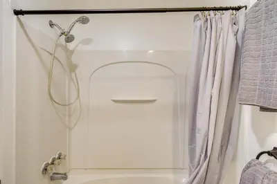 a shower in a bathroom with a shower curtain at 1 Mi to Freer Field Ashland Home with Yard! in Ashland