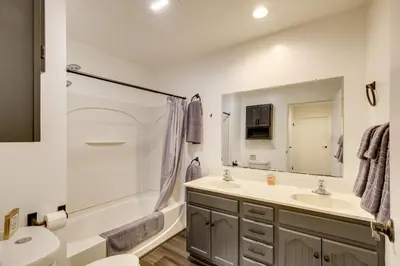 a bathroom with a sink and a toilet and a mirror at 1 Mi to Freer Field Ashland Home with Yard! in Ashland