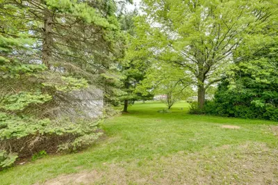 a green yard with trees and grass at 1 Mi to Freer Field Ashland Home with Yard! in Ashland