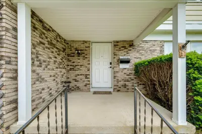 a front door of a house with a brick wall at 1 Mi to Freer Field Ashland Home with Yard! in Ashland