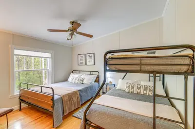 a bedroom with two bunk beds and a ceiling fan at Walk to River Loudonville Retreat with Hot Tub! in Loudonville
