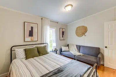 a bedroom with a bed and a couch at Walk to River Loudonville Retreat with Hot Tub! in Loudonville