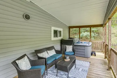 a patio with chairs and a grill on a deck at Walk to River Loudonville Retreat with Hot Tub! in Loudonville