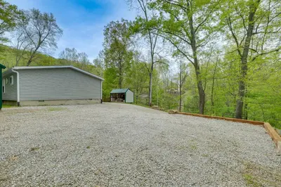 a large driveway with a garage and a building at Walk to River Loudonville Retreat with Hot Tub! in Loudonville