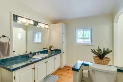 a bathroom with a sink and a mirror and a toilet at Walk to River Loudonville Retreat with Hot Tub! in Loudonville