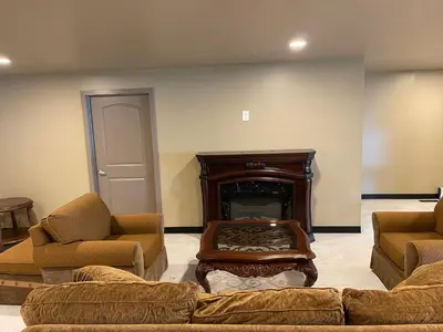 a living room with a couch and a fireplace at Four Seasons Inn in Gallipolis