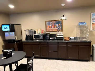a coffee shop with a counter and a table at Four Seasons Inn in Gallipolis
