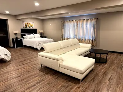 a living room with a couch and a bed at Four Seasons Inn in Gallipolis