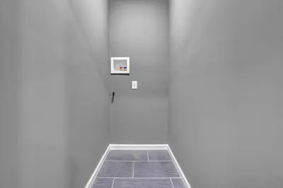 an empty room with a white wall and a door at Tremont Jewel Group Stay in the Heart of Tremont in Cleveland