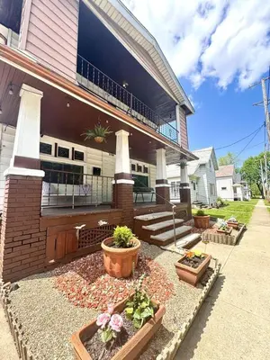 a house with three potted plants in front of it at Sleep with a Lion!! 6 bedroom house, near downtown, Ohio city Tremont! in Cleveland