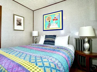a bedroom with a bed with a colorful blanket at Sleep with a LION! 3 bedroom, near Downtown, Tremont, Ohio city!! in Cleveland