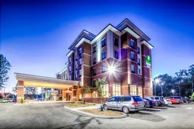 a building with cars parked in a parking lot at Holiday Inn Express & Suites Cleveland/Westlake by IHG in Westlake