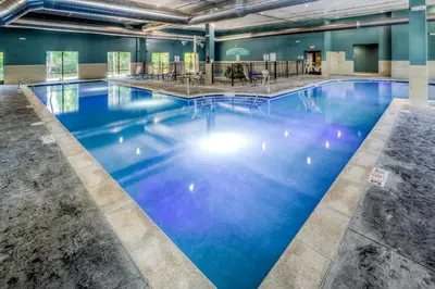 a large pool with blue water in a building at Holiday Inn Express & Suites Cleveland/Westlake by IHG in Westlake