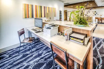 an office with a desk with a computer and chairs at Holiday Inn Express & Suites Cleveland/Westlake by IHG in Westlake