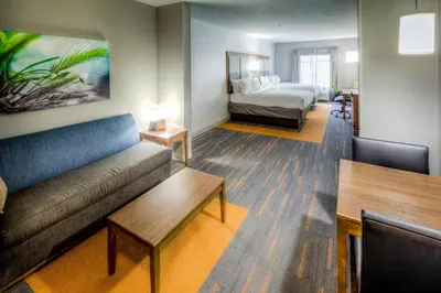 a living room with a couch and a bed at Holiday Inn Express & Suites Cleveland/Westlake by IHG in Westlake