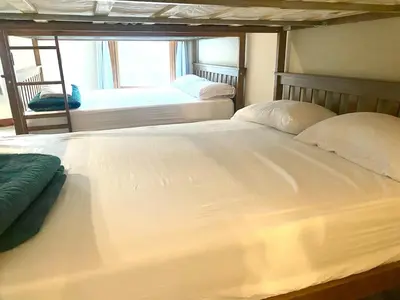 two white beds in a room with a window at The Billy Lodge in Lucas