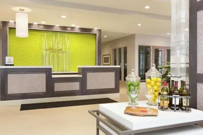 a room with a table with drinks and bottles of wine at Hilton Garden Inn Pittsburgh Airport South-Robinson Mall in Robinson Township