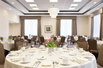 a conference room with tables and chairs with white tablecloths at Hilton Garden Inn Pittsburgh Airport South-Robinson Mall in Robinson Township