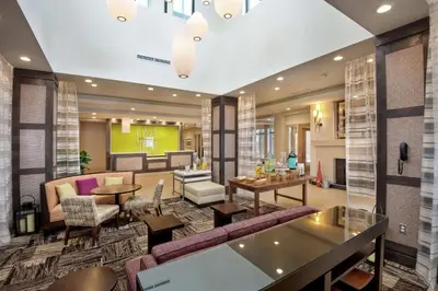 a lobby of a hotel with purple furniture at Hilton Garden Inn Pittsburgh Airport South-Robinson Mall in Robinson Township