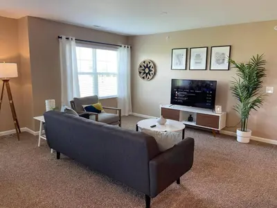 a living room with a couch and a tv at Retreat At The Charles Fast WiFi WasherDryer in Dublin