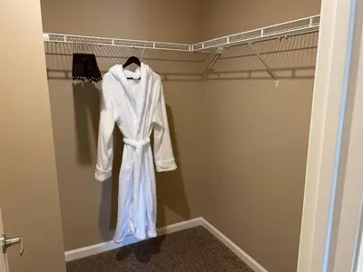 a white robe is hanging in a closet at Retreat At The Charles Fast WiFi WasherDryer in Dublin