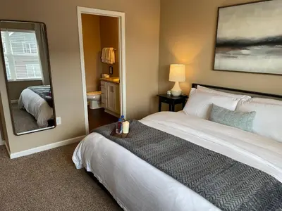 a bedroom with a large white bed and a mirror at Retreat At The Charles Fast WiFi WasherDryer in Dublin