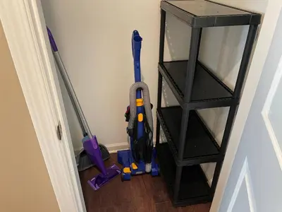 a room with two vacuum cleaners and a shelf at Retreat At The Charles Fast WiFi WasherDryer in Dublin