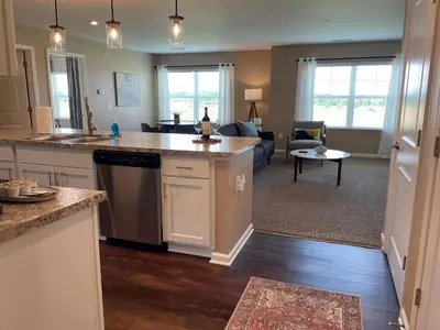 an open kitchen and living room with a couch at Retreat At The Charles Fast WiFi WasherDryer in Dublin