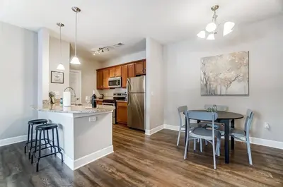 a kitchen and dining room with a table and chairs at Paws Of Polaris 2BR 1st Floor Walk-In Shower in Westerville