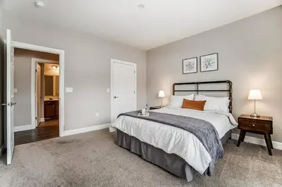 a bedroom with a large bed and a bathroom at Paws Of Polaris 2BR 1st Floor Walk-In Shower in Westerville