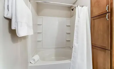 a bathroom with a tub and a white shower curtain at Paws Of Polaris 2BR 1st Floor Walk-In Shower in Westerville