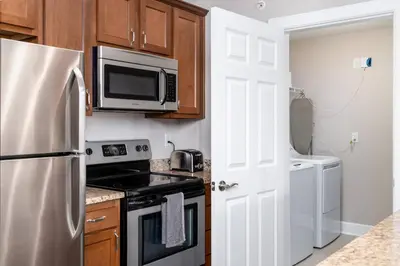 a kitchen with a refrigerator and a microwave at The Pondview Penthouse King Bed Balcony WD in Westerville