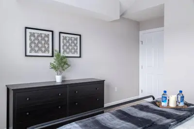 a bedroom with a bed and a dresser at The Pondview Penthouse King Bed Balcony WD in Westerville