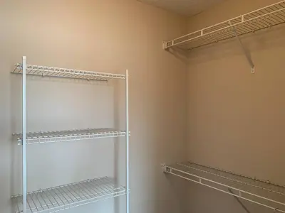 a walk in closet with empty shelves in it at The Pondview Penthouse King Bed Balcony WD in Westerville