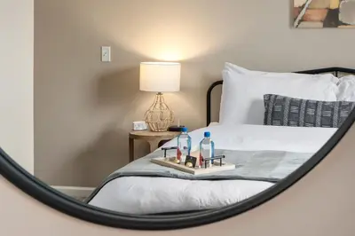 a mirror reflection of a bed in a bedroom at Cozy Dublin 2BR 1st Floor Easy Free Parking! in Dublin