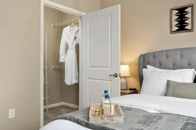 a bedroom with a white bed and a closet at Cozy Dublin 2BR 1st Floor Easy Free Parking! in Dublin
