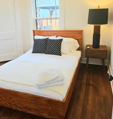 a bedroom with a bed with a wooden headboard at The Chelsea in Dayton