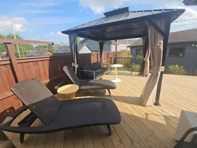 a deck with two chairs and a gazebo at The Chelsea in Dayton