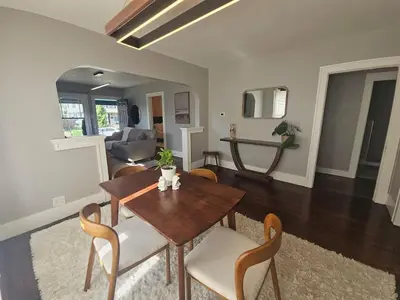 a dining room and living room with a table and chairs at The Chelsea in Dayton