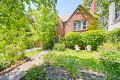 a garden with two chairs and a house at Historic University Heights Home with Private Yard! in University Heights