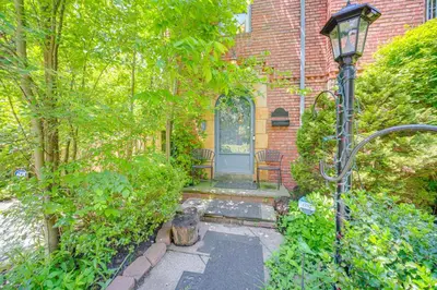a home with a street light in front of a building at Historic University Heights Home with Private Yard! in University Heights