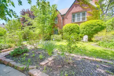 a garden in front of a brick house at Historic University Heights Home with Private Yard! in University Heights