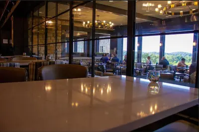 a table in a restaurant with people sitting at tables at Oglebay Resort in Wheeling