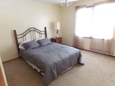 a bedroom with a large bed and a window at Family Friendly lodge located in the Hocking Hills in Rockbridge